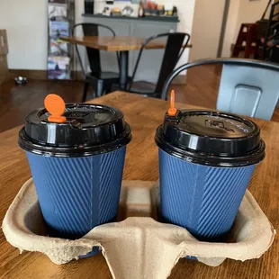 two cups of coffee on a tray