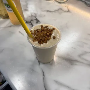 a smoothie in a plastic cup with a straw