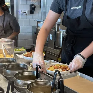 a woman preparing food in a kitchen