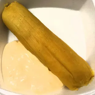 Tamale Elote. Slightly sweet corn Tamale. Comes with a side of cream. Great with Coffee