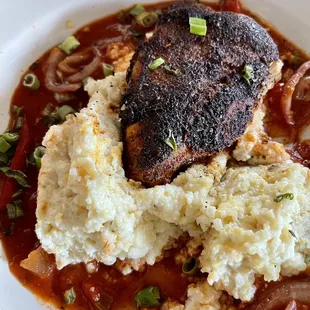 Blackened chicken and grits in a Cajun sauce