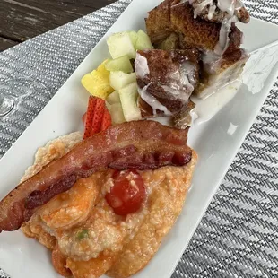 Shrimp and grits, bacon, fresh fruit and French toast.