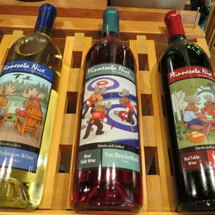 three bottles of wine in a wooden crate