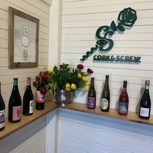 bottles of wine lined up on a shelf