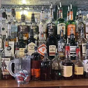 a variety of liquor bottles on a bar counter