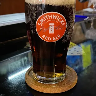 a pint of beer on a coaster