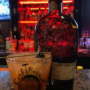  shot of a drink and a bottle