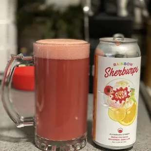  glass of soda next to a can