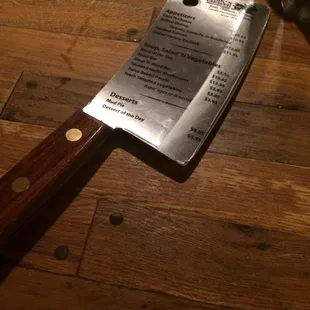 The menu is on a very heavy butcher knife. A very original and cute idea.
