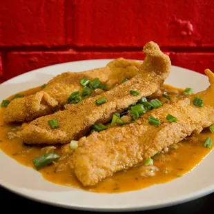 True Louisiana Crawfish Etouffee topped with 3pc of Delicious Cajun Fried Fish