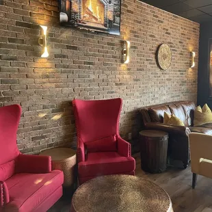 a living room with a brick wall