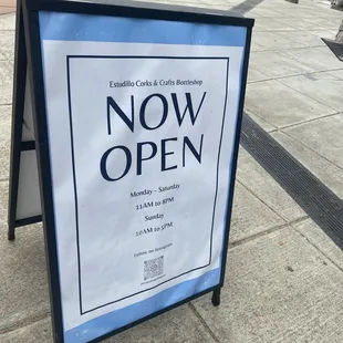 Standing board in front of store.