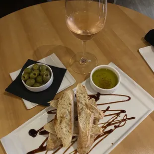 a plate of food and a glass of wine