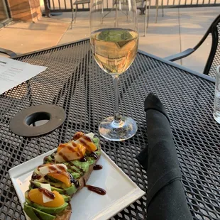 a glass of wine and a plate of food