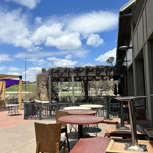 a patio with tables and chairs