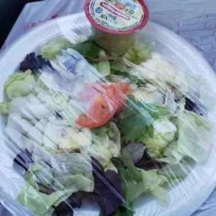 Grocery store bagged salad with two tomatoes, with the lunch special.