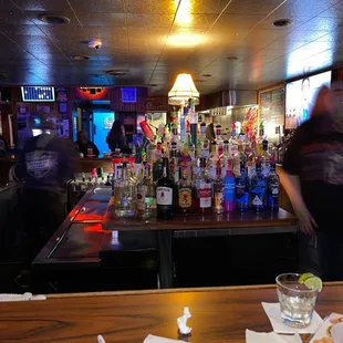 a bar with a lot of bottles of alcohol