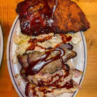 a plate of ribs and coleslaw