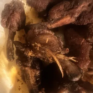 Smoked chicken wings with feathers