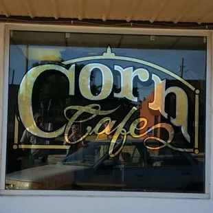 the reflection of the sign in the window