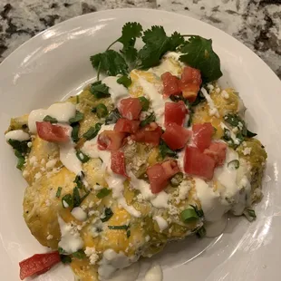 Carnita enchilada with cilantro lime crema