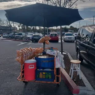 a corn vendor selling corn on the side of the road