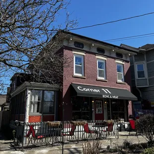 Sunroom seen on the left, a front patio seen in the foreground, and a side patio with additional seating (not pictured here)