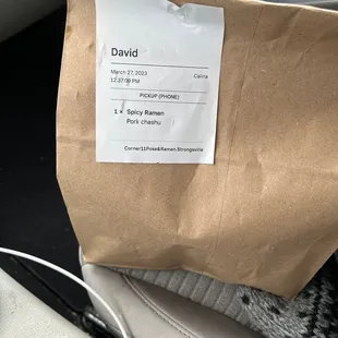 a brown paper bag with a sticker on it