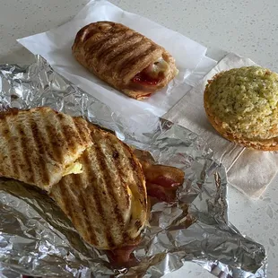 Bacon &amp; Cheddar Panini, Strawberry &amp; Cream Cheese Croissant, Lemon Poppyseed Muffin