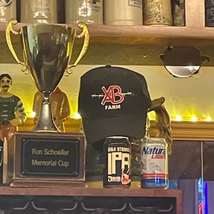 trophies and beer glasses on shelves