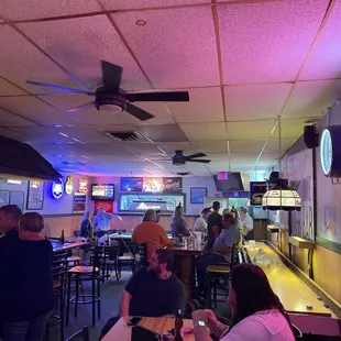 people sitting at tables in a restaurant