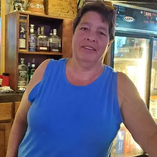 a woman standing behind a counter