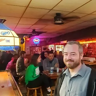 a man standing in front of a bar