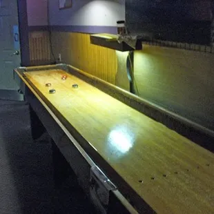a shuffler table in a dimly lit room