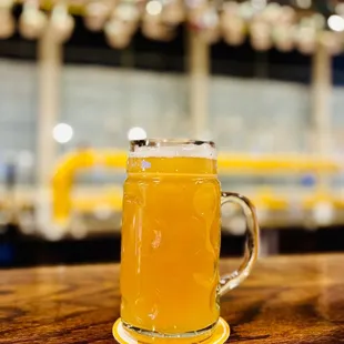 a glass of beer on a wooden table