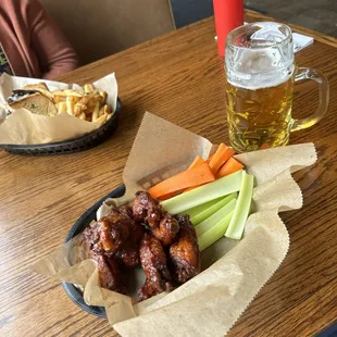 Loner Hand Italian Pilsner, and barbecue wings with celery and carrots.