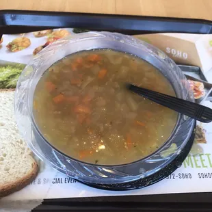 a bowl of soup and a slice of bread