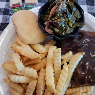 Full view of my meal, Hamburger steak, Collard greens, fries and a roll.