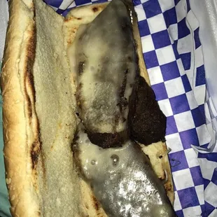 a cheeseburger sandwich on a paper plate