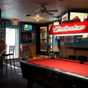 a woman leaning over a pool table