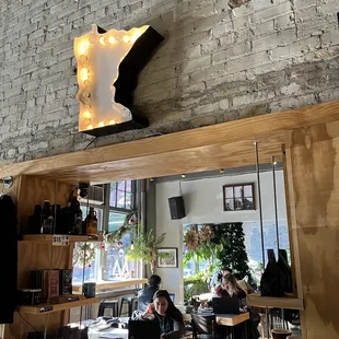 two people sitting at tables in a coffee shop