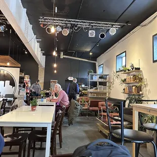 people sitting at tables in a coffee shop