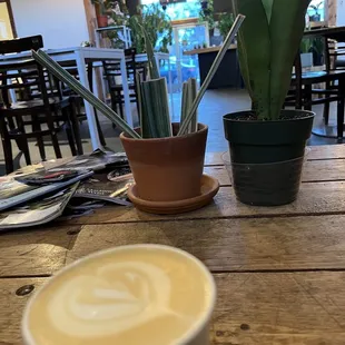 a cup of cappuccino on a wooden table