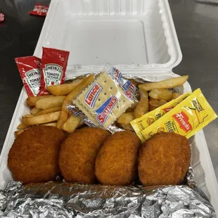 Cod fish cakes plater with corn and French fries
