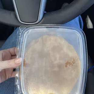 a person holding a container of food