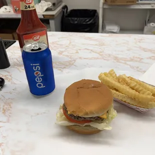 Cheese burger, fries and a Pepsi.