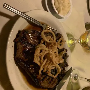 32oz Porterhouse Steak with mushrooms and onion straws.