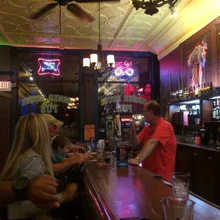 a bartender serving customers