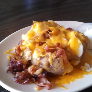 Loaded baked potato for only $4, with caramelized onions, shredded cheese, butter, bacon, and sour cream.