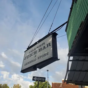 a sign hanging from the side of a building